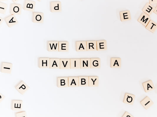 Scrabble tiles forming the words “We are having a baby”