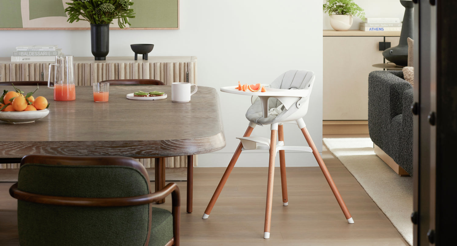 The Lalo High Chair next to a dining table