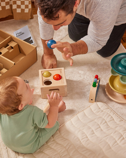 baby playing with dad