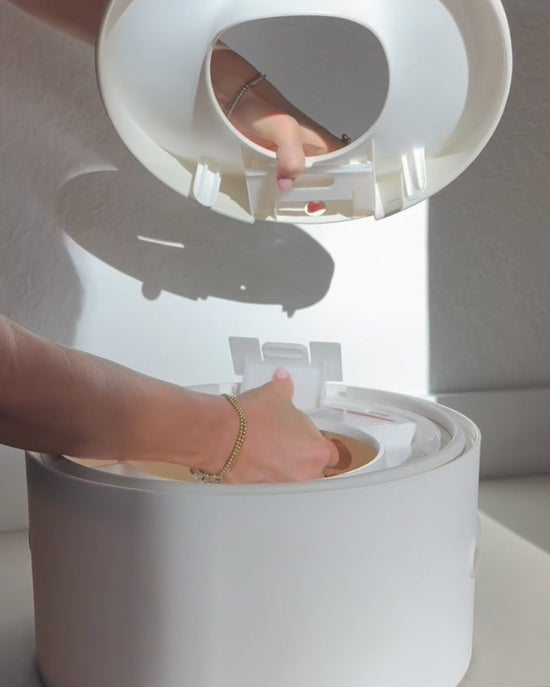 Person removing the toilet seat trainer