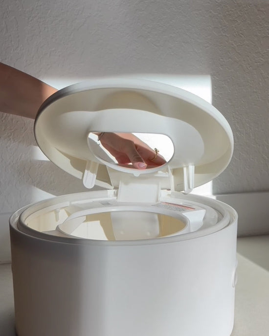 Person placing the toiler seat trainer back on the potty